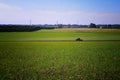 A green tractor working in a field with a subsoiler Royalty Free Stock Photo