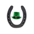 Green traditional leprechaun hat and iron horseshoe symbol of good luck on white background Royalty Free Stock Photo