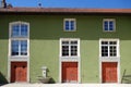 Green Traditional Swiss Building with Red Doors Royalty Free Stock Photo