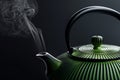 Green traditional teapot with steam