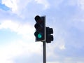 Green traffic light against blue sky Royalty Free Stock Photo