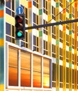 Green traffic light against colorful building Royalty Free Stock Photo