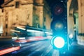 Green on traffic light against light trails of tram Royalty Free Stock Photo