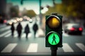 green traffic light, with blurred background of passing cars and pedestrians