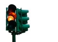 Green traffic light with burning yellow lamp