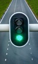 Green traffic light with empty highway on background, concept for going forward, positivity, success