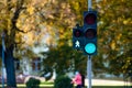 Green traffic light in semaphore closeup. Bright colored autumn background Royalty Free Stock Photo