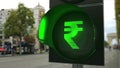 Rupee sign on green traffic light signal. Forex related conceptual 3D rendering