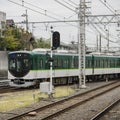 Green train enters local station in Kyoto, Royalty Free Stock Photo