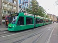 Green tram driving through the historic center Grossbasel. City of Basel, Switzerland. Royalty Free Stock Photo