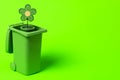 Green trash can with flowers on a green background Royalty Free Stock Photo