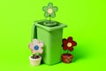 Green trash can with flowers on a green background Royalty Free Stock Photo