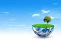 Green tree growth on blue planet earth with blue sky and white clouds in background. Royalty Free Stock Photo