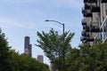 Green Trees next to a Row of Apartment Buildings with Balconies and the Chicago Skyline in the Distance Royalty Free Stock Photo