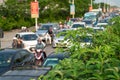 Green trees on road side with background of cars on urban street in traffic jam at rush hour in big city Royalty Free Stock Photo