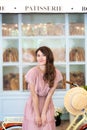 Green trip healthy concept, Eco transport. Romantic girl standing near her bike on the background of a bakery cafe. Portrait of a Royalty Free Stock Photo