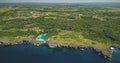 Green tropic forest at cliff sea bay with turquoise salt water lake aerial view. Epic nature scenery Royalty Free Stock Photo