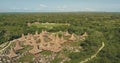 Green tropic forest with traditional houses village aerial view. Indonesia tourist attraction