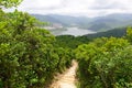 Green Tropical mountains and hiking route on the Dragon's Back trail near Hong Kong Royalty Free Stock Photo