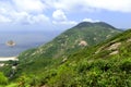 Green Tropical mountains and hiking route on the Dragon's Back trail near Hong Kong Royalty Free Stock Photo