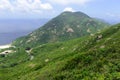 Green Tropical mountains and hiking route on the Dragon's Back trail near Hong Kong Royalty Free Stock Photo