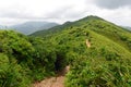 Green Tropical mountains and hiking route on the Dragon's Back trail near Hong Kong Royalty Free Stock Photo