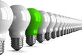 Green tungsten light bulb and many white ones, perspective view Royalty Free Stock Photo