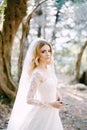 Green twig in the hands of the bride in a white embroidered dress Royalty Free Stock Photo