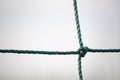 Green twisted rope with a knot