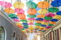 Green umbrellas on the city street in the summer