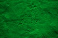 Green uneven rough texture. Painted old wall with plaster. Classic green color. Grunge surface background for design. Royalty Free Stock Photo