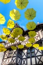 Green upside down umbrellas in a street, Thiers (France)