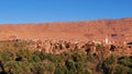 Green valley with date palm trees in the Altas Mountains in Berber city Tinghir, Morocco with old loam buildings. Royalty Free Stock Photo