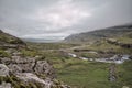 A green valley with foggy mountains and a river in iceland