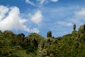 Green valley and rock formations under blue sky Royalty Free Stock Photo