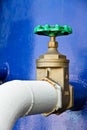 Green valve and blue tank. Royalty Free Stock Photo
