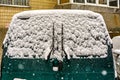 A green van covered in snow in front of a house Royalty Free Stock Photo