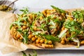 Green vegan pizza with pesto, chickpeas, champignons and arugula