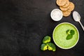 Green vegetable cream soup - broccoli - on black kitchen table top view copy space Royalty Free Stock Photo