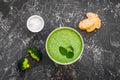 Green vegetable cream soup - broccoli - on grey kitchen table top view Royalty Free Stock Photo