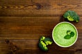 Green vegetable cream soup - broccoli - on wooden kitchen table top view copy space Royalty Free Stock Photo