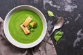 Green vegetable cream soup with spinach on a dark concrete background. Dietary healthy lunch or dinner. Top view, copy space Royalty Free Stock Photo