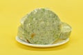 Green vegetable cutlets in plate on yellow background. Frozen veggie cutlets made from green vegetables Royalty Free Stock Photo