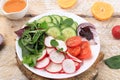 Green vegetable salad with cherry tomatoes, cucumber, radish and fresh arugula, detox diet. Healthy natural breakfast for weight Royalty Free Stock Photo