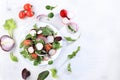 Green vegetable salad with cherry tomatoes, cucumber, radish and fresh arugula on a sunny table with shadows, detox diet. Healthy Royalty Free Stock Photo