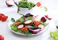 Green vegetable salad with cherry tomatoes, cucumber, radish and fresh arugula on a sunny table with shadows, detox diet. Healthy Royalty Free Stock Photo