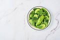 Green vegetable salad with spinach, avocado, green peas and olive oil in bowl on light gray slate, stone or concrete background. Royalty Free Stock Photo