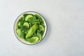 Green vegetable salad with spinach, avocado, green peas and olive oil in bowl on light gray slate, stone or concrete background. Royalty Free Stock Photo