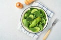 Green vegetable salad with spinach, avocado, green peas and olive oil in bowl on light gray slate, stone or concrete background. Royalty Free Stock Photo