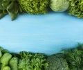 Green vegetables. Green vegetable on blue wooden background. Spinach, lettuce, cabbage, broccoli, cucumbers, parsley and dill. Top